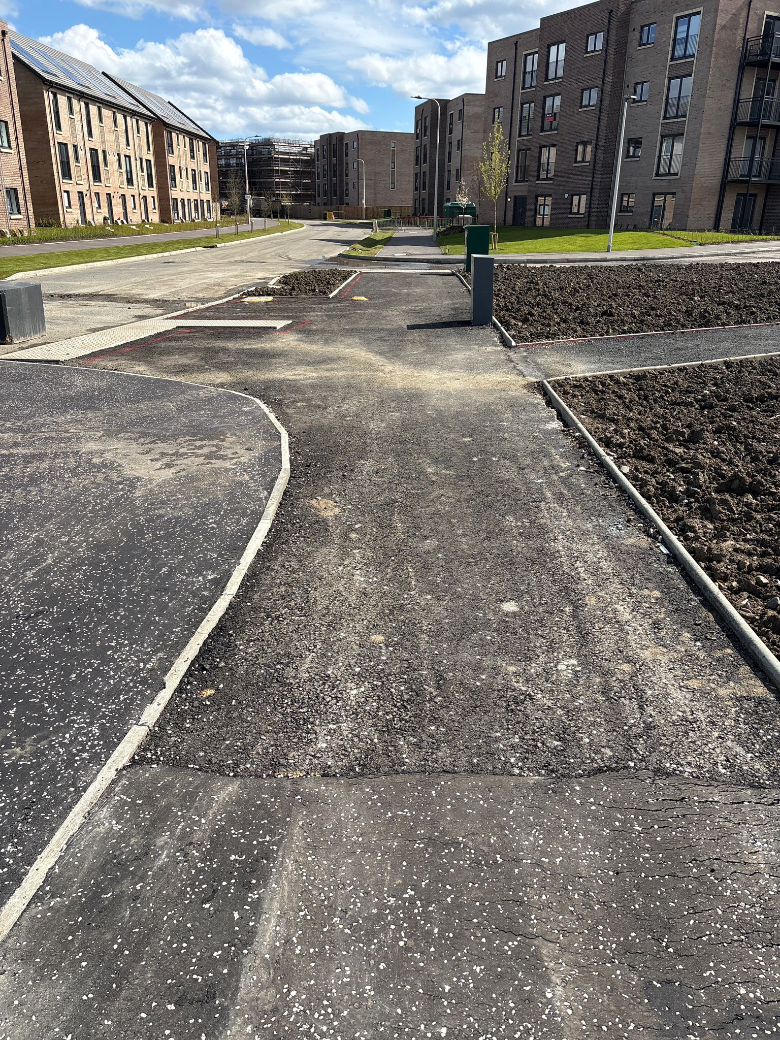 Footpath and access route nearing completion with kerbing and surface preparation in place