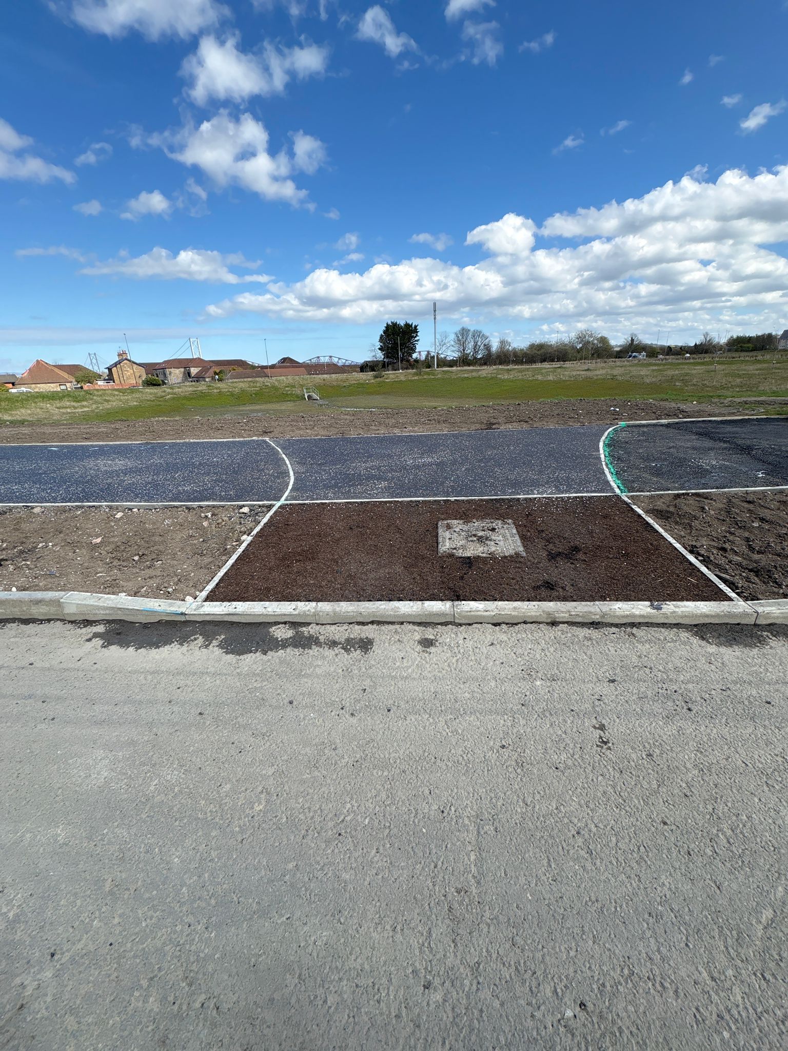 Junction area with newly formed footpaths and kerbing prepared for final landscaping