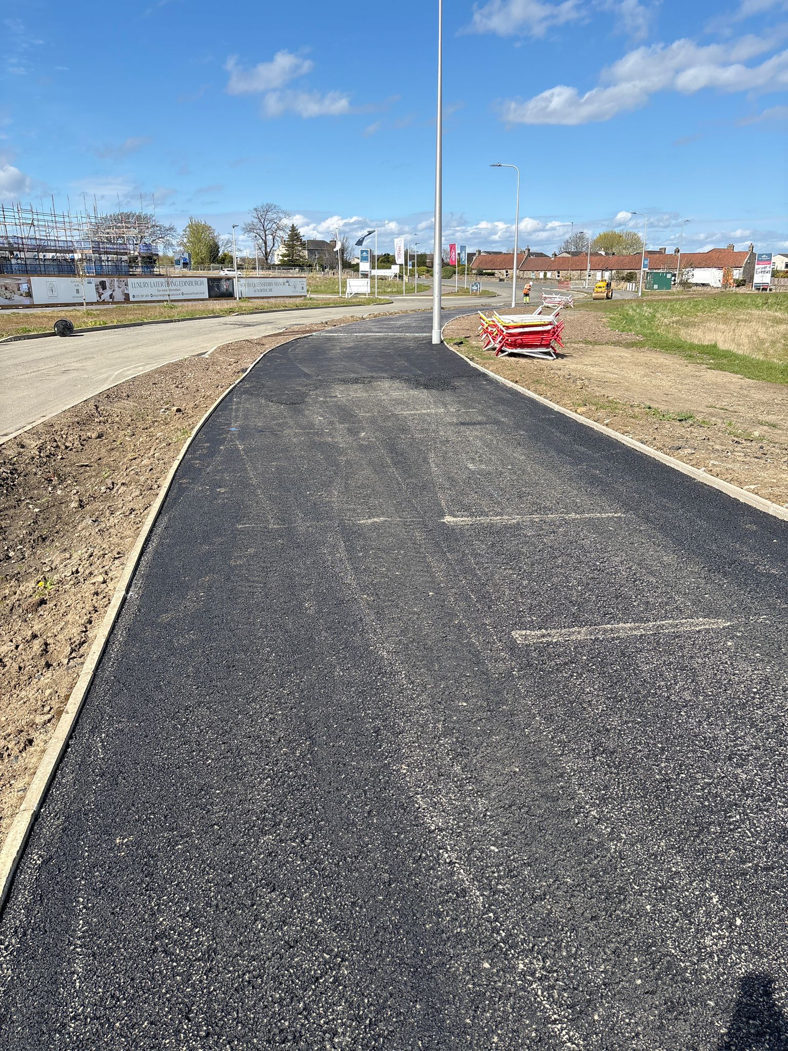 Curved pedestrian pathway with uniform asphalt finish and clean transitions