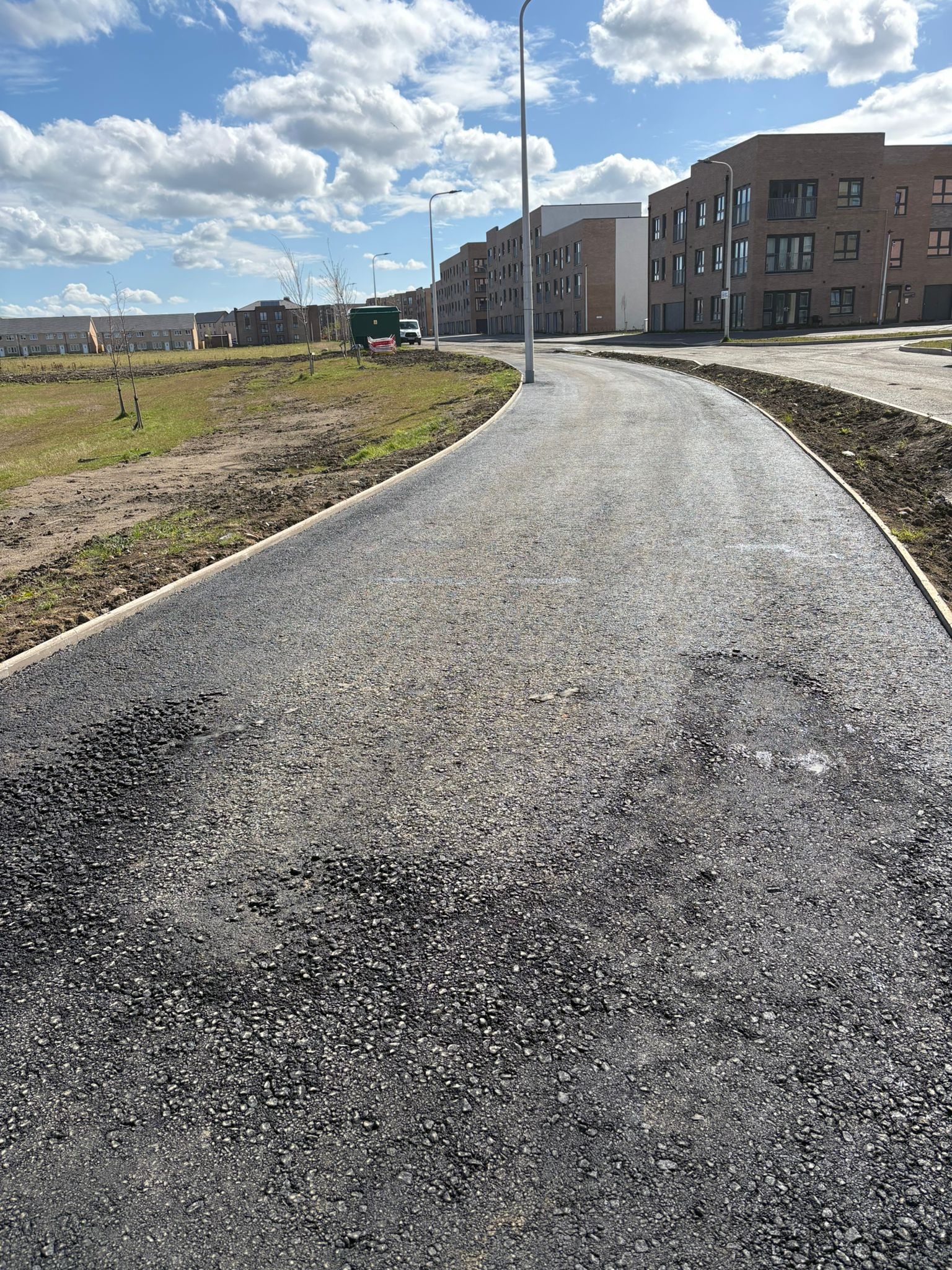 Newly surfaced roadway demonstrating texture, compaction, and readiness for use