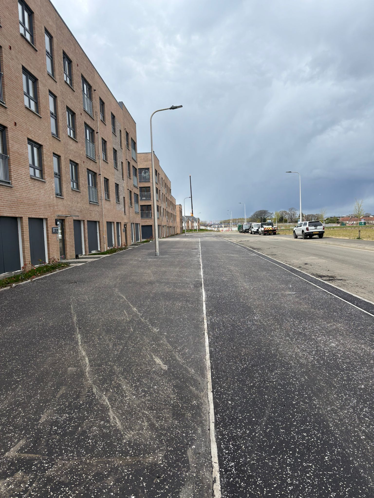 Wide view of completed road and footway highlighting overall layout and infrastructure integration