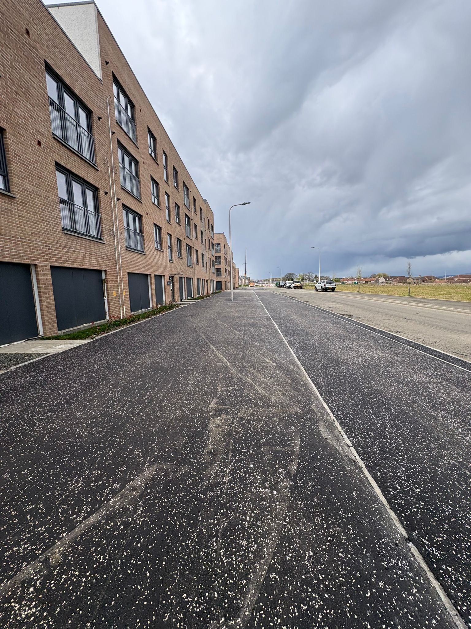 Completed roadway and footpath with consistent surfacing and alignment through the residential development
