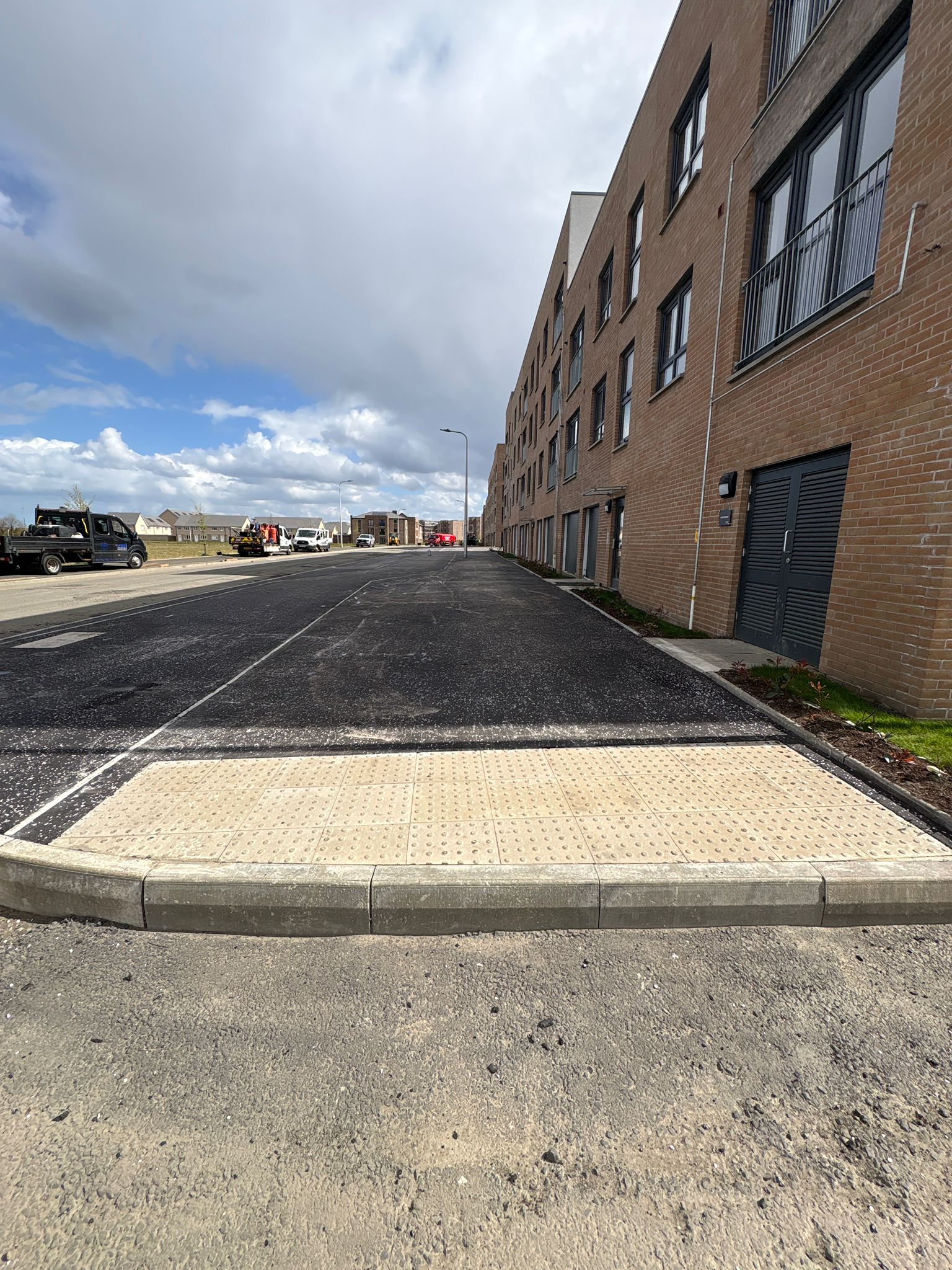 Completed footway with tactile paving and dropped kerb providing safe and accessible crossing points