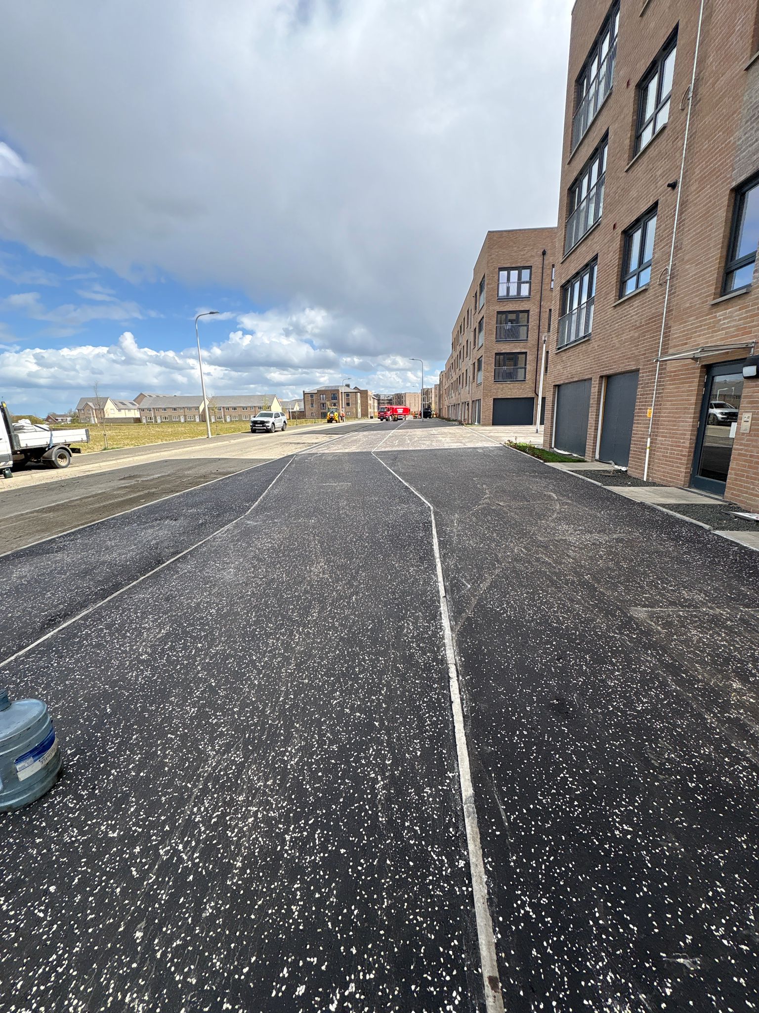 Completed roadway section with defined parking bays and clean surface finish