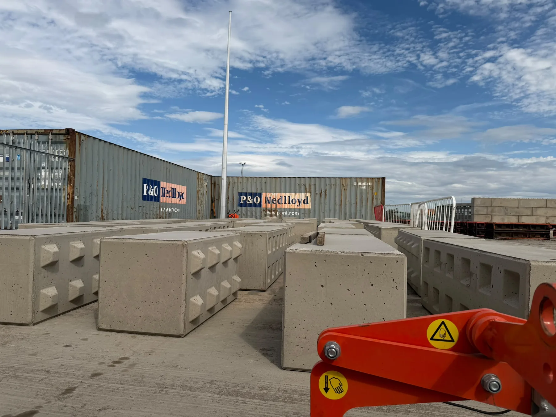 Completed modular concrete blocks lined up in the production yard